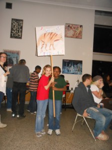 Photo of third graders holding a "save the striped hyena" sign