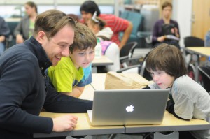 Researcher with kids and laptop