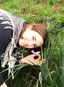 Raffica’s face next to an iris flower.