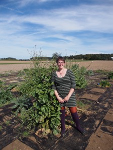 Amanda Charbonneau next to one of her tallest plants - she's 5'6"!
