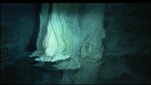 IMAX flange on the northwestern side of the 60-meter-tall Poseidon chimney at the Lost City Hydrothermal Field, venting 55°C, pH 11 fluids. Image courtesy of IFE, URI-JAO, Lost City Science Party, and NOAA.